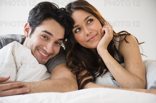 Couple relaxing together in bed