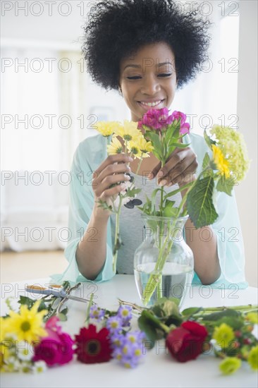 African American woman arranging flowers