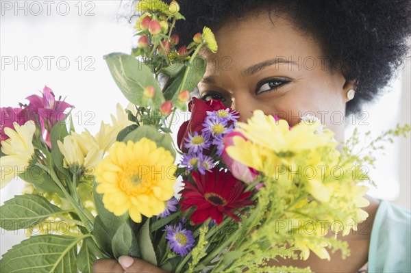 African American woman holding bouquet of flowers