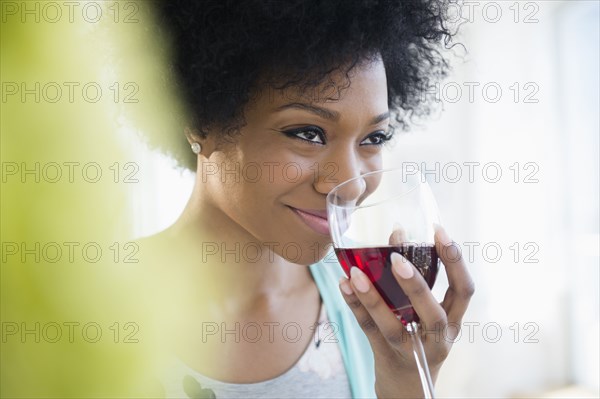 African American woman drinking glass of wine