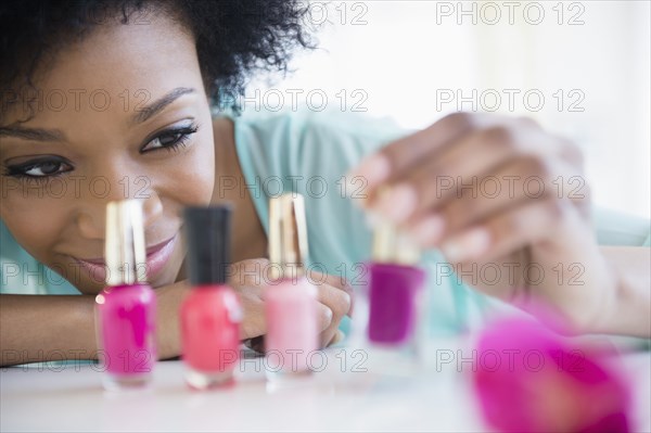 African American woman painting her nails