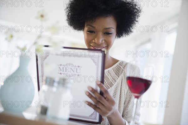 African American people reading menu at restaurant