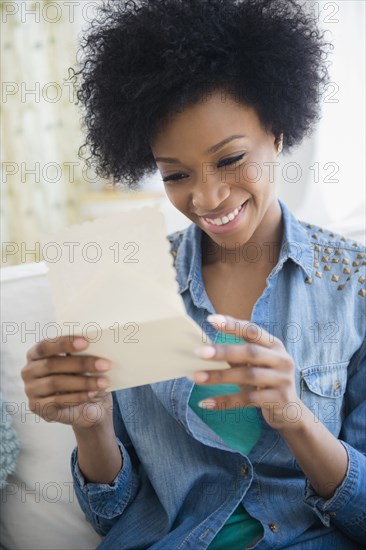 African American woman reading letter