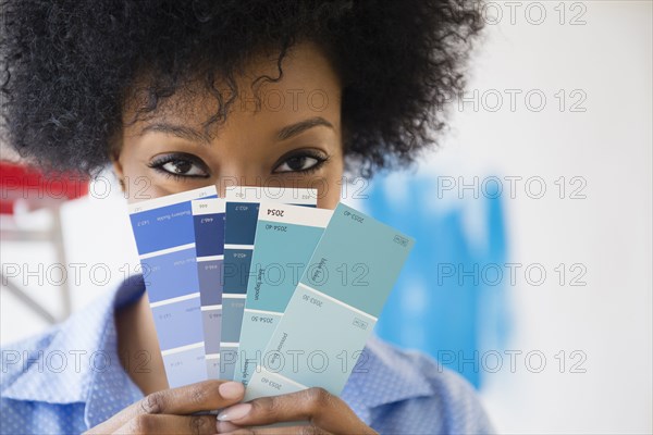 African American woman holding paint swatches