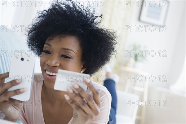 African American woman shopping on cell phone