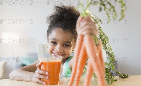 African American girl drinking carrot juice