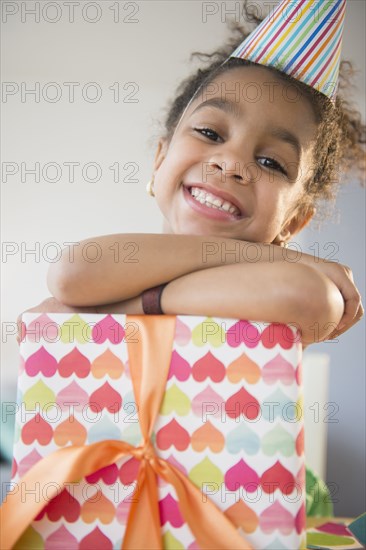 African American girl holding wrapped birthday gift