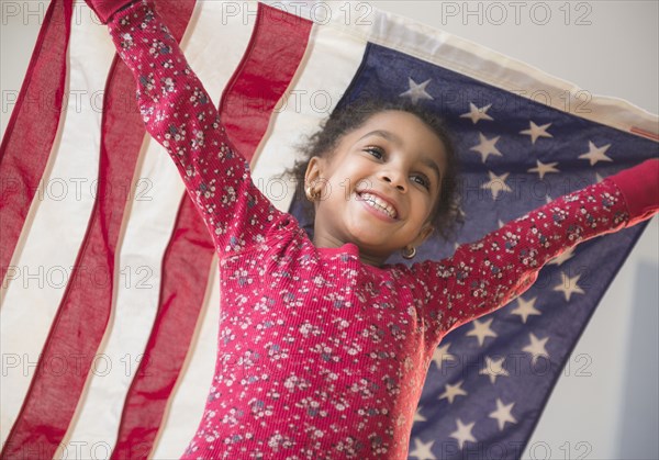 African American girl playing with United States flag
