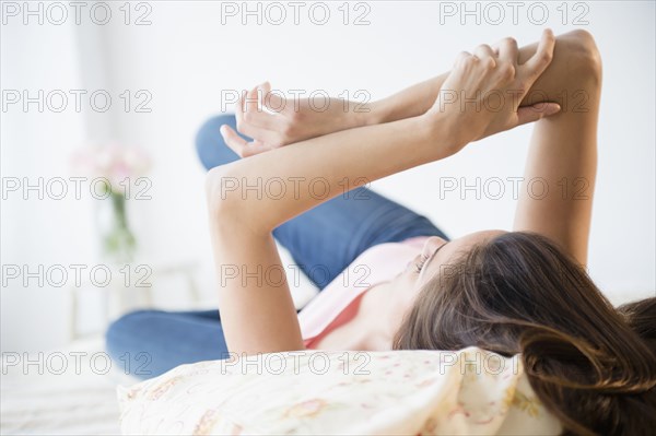 Woman relaxing on bed