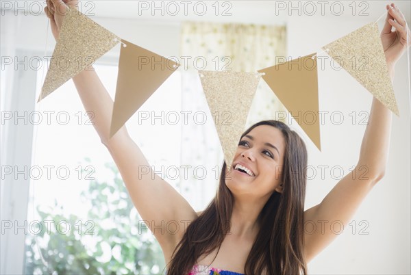 Woman holding bunting flags in living room