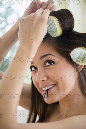 Woman putting her hair up in curlers