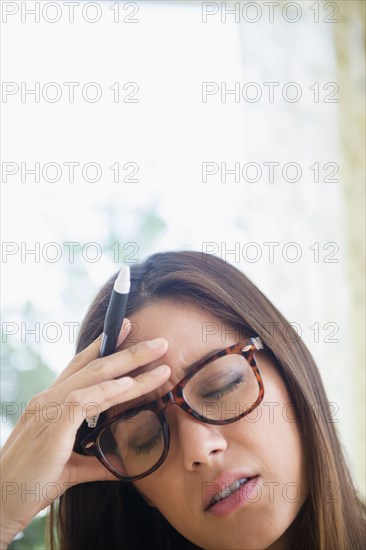 Frustrated woman rubbing her forehead