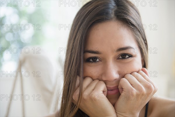 Woman resting chin in hands