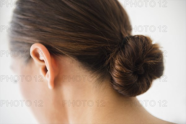 Close up of woman wearing bun in hair