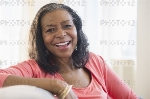 Mixed race woman relaxing on sofa