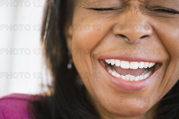 Close up of mixed race woman laughing