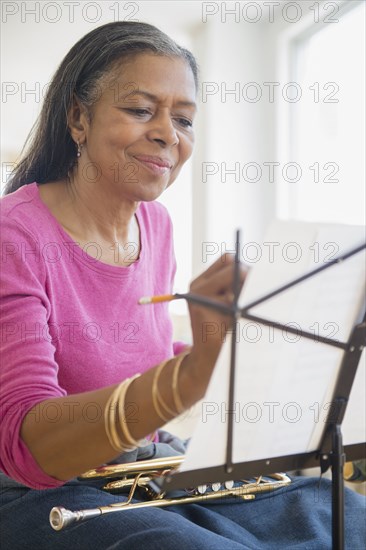 Mixed race woman playing trumpet