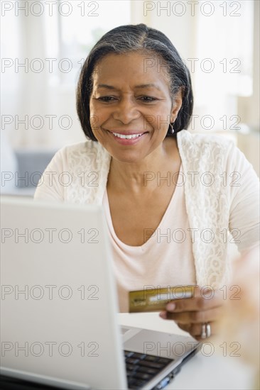 Mixed race woman shopping on laptop