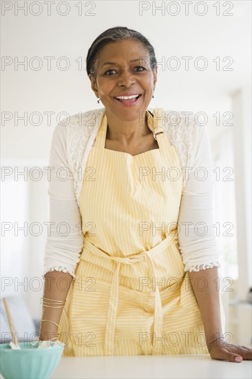 Mixed race woman cooking in kitchen