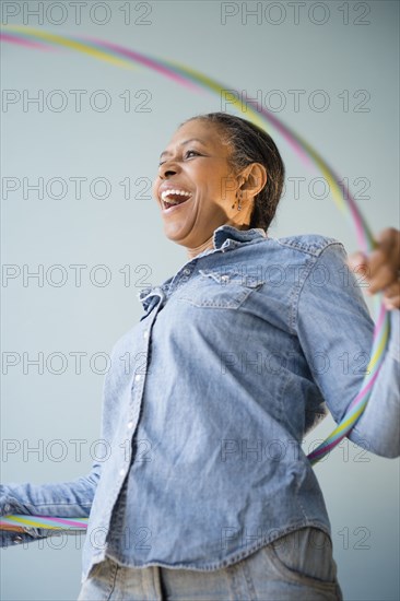 Mixed race woman holding plastic ring