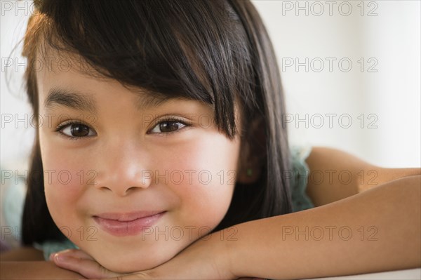 Filipino girl resting chin in hands