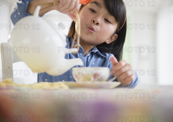 Filipino girl pouring tea