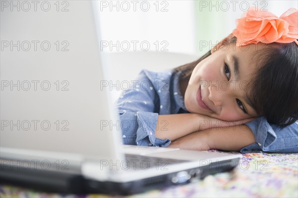 Filipino girl using laptop at desk