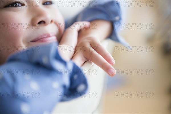 Close up of Filipino girl resting chin in hands