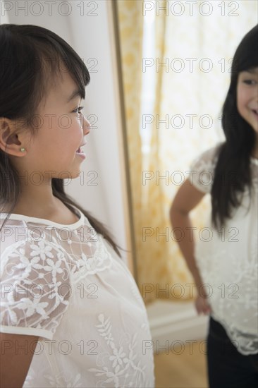 Filipino girl admiring herself in mirror