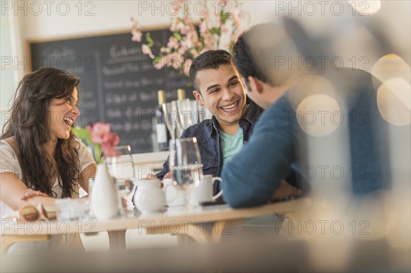 Hispanic friends talking in cafe