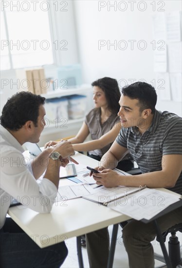 Hispanic business people working together in office