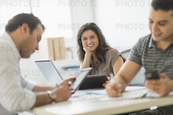 Hispanic business people working in office