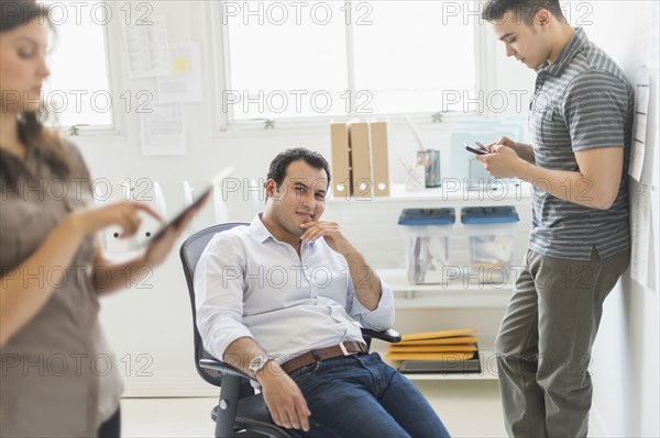 Hispanic businessman smiling in office