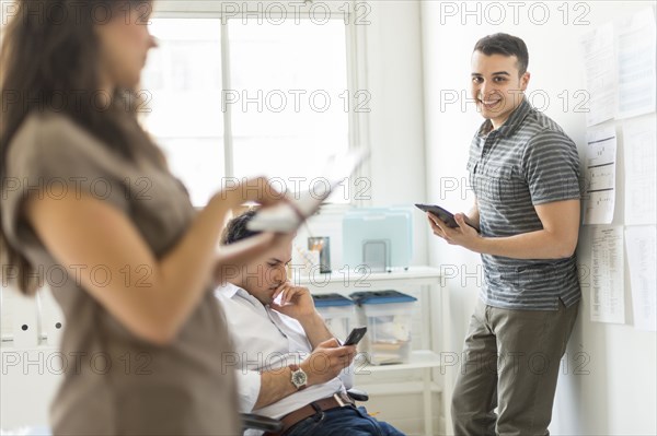 Hispanic business people using technology in office