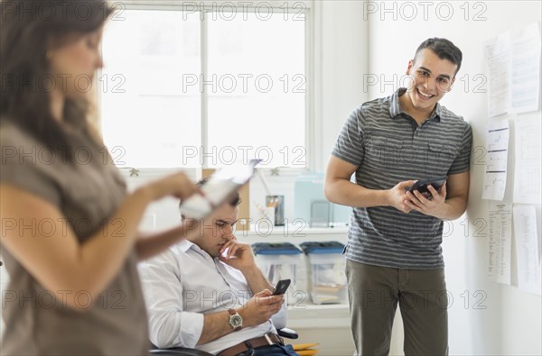 Hispanic business people using technology in office