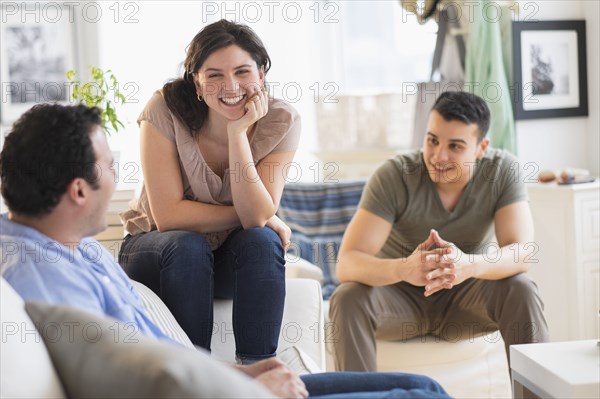 Hispanic friends talking in living room