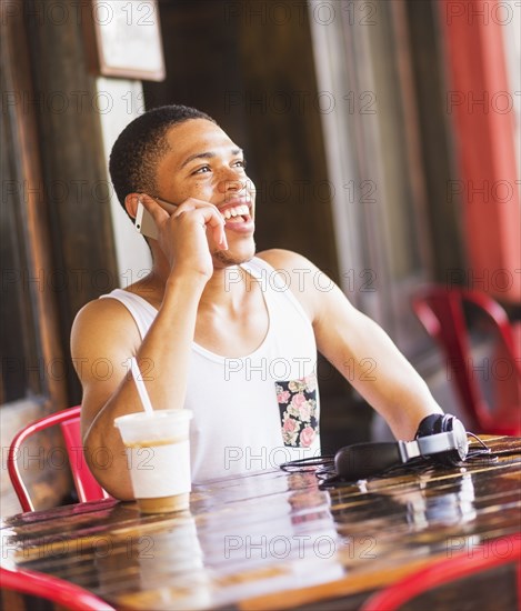 African American man talking on cell phone at cafe