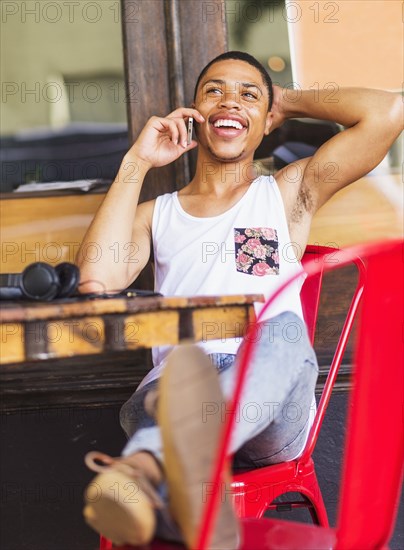 African American man talking on cell phone at cafe