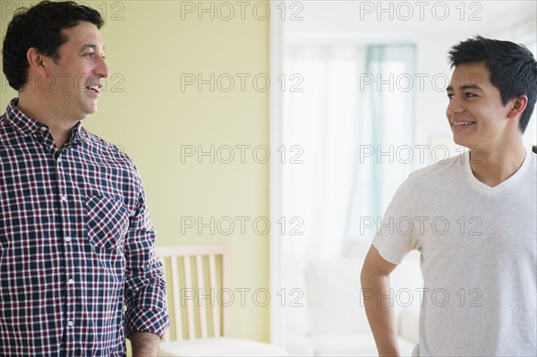 Hispanic father and son talking