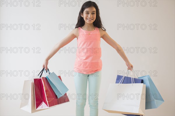 Hispanic girl holding shopping bags