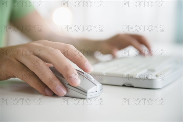 Mixed race man using wireless mouse and keyboard