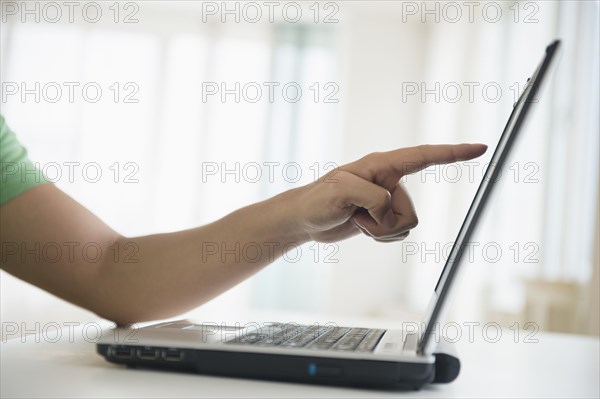 Mixed race man pointing to laptop screen