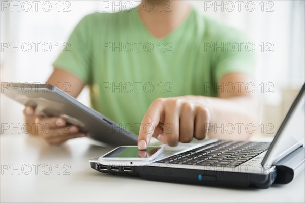 Mixed race man using cell phone