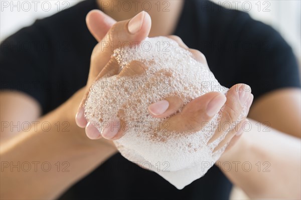 Close up of mixed race man washing his hands