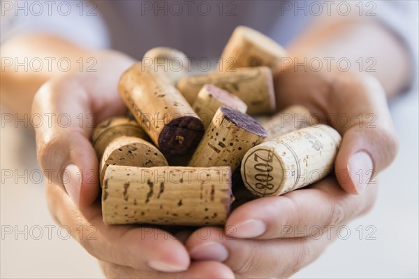 Close up of mixed race man holding wine corks
