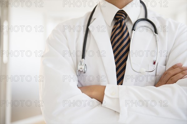 Close up of mixed race doctor with arms crossed