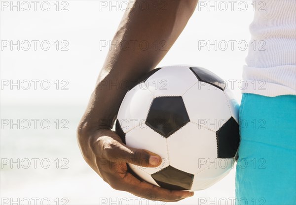 Mixed race man holding soccer ball