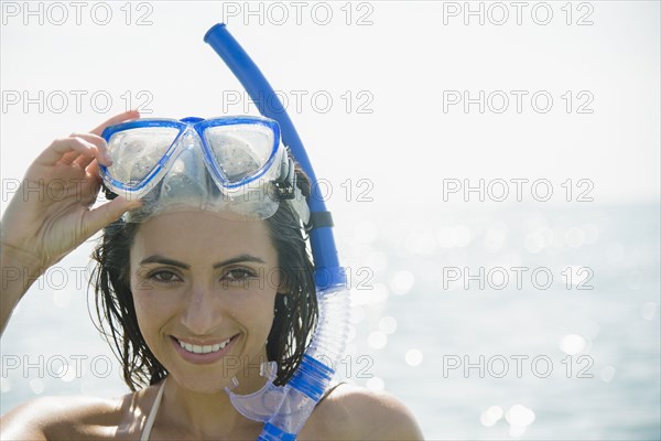 Caucasian woman wearing snorkel and mask in ocean