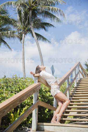 Caucasian woman standing on wooden staircase