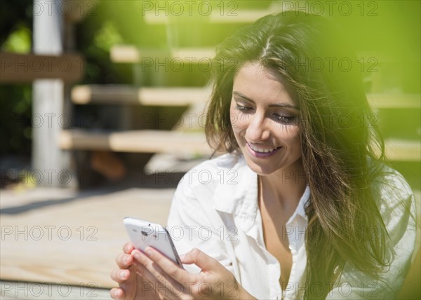 Caucasian woman using cell phone outdoors